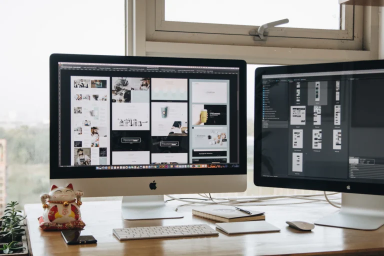 A web designer’s desk with two monitors